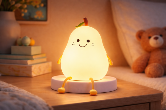 Color-changing silicone pear night light glowing warm yellow on a bedroom nightstand
